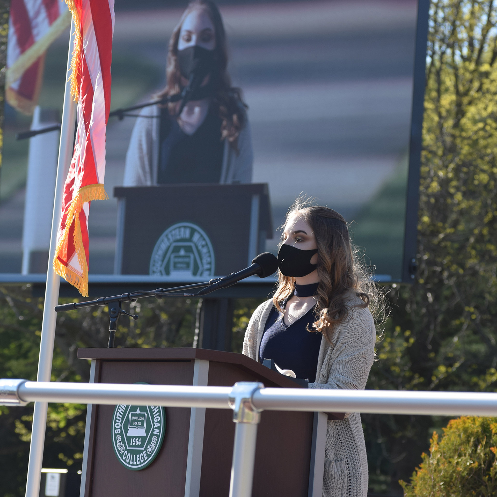 Speaking at the 2021 outdoor Outstanding Graduates Reception in Alumni Plaza